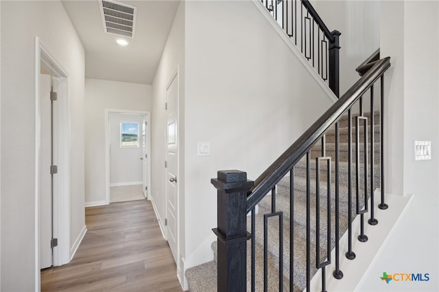 staircase featuring wood-type flooring