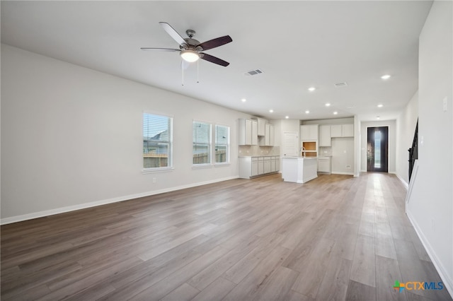 unfurnished living room with light hardwood / wood-style floors and ceiling fan