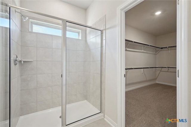 bathroom featuring a shower with door