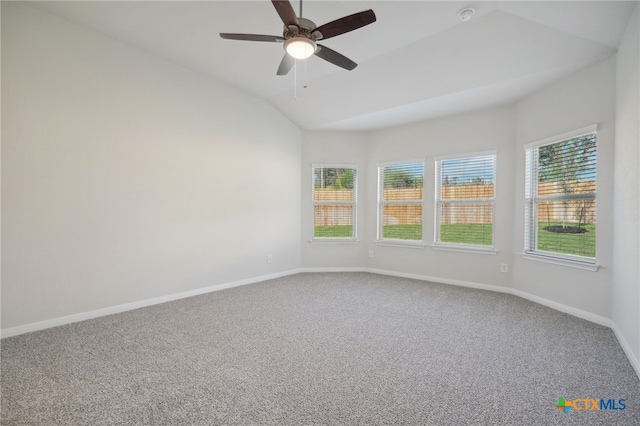 carpeted spare room featuring lofted ceiling, ceiling fan, and a healthy amount of sunlight