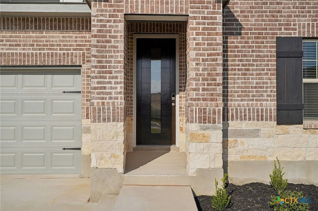property entrance featuring elevator and a garage