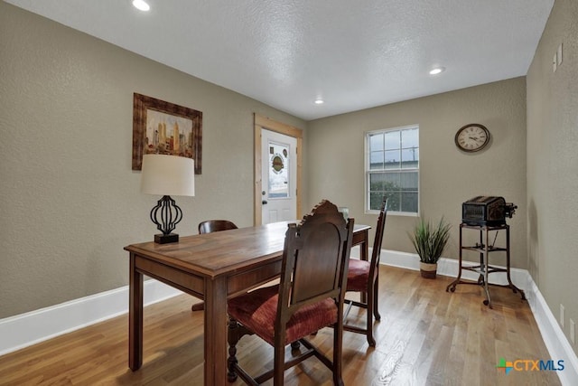 608 S Guadalupe St, San Marcos, TX 78666 - dining room with light wood-style flooring, a textured wall, recessed lighting, and a textured ceiling