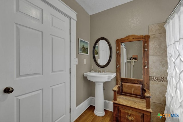 608 S Guadalupe St, San Marcos, TX 78666 - bathroom featuring wood finished floors and a sink