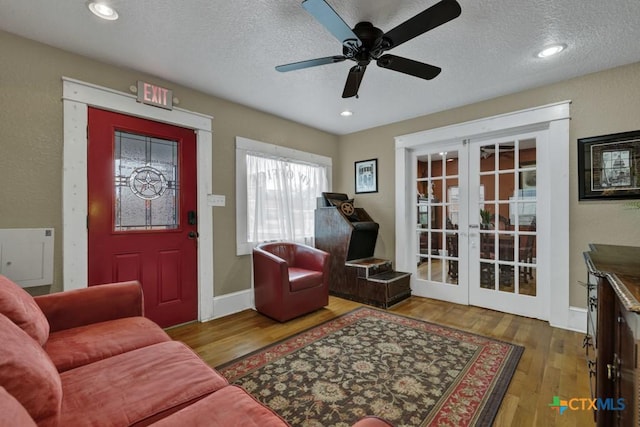 608 S Guadalupe St, San Marcos, TX 78666 - living area with french doors, a textured ceiling, wood finished floors, ceiling fan, and recessed lighting