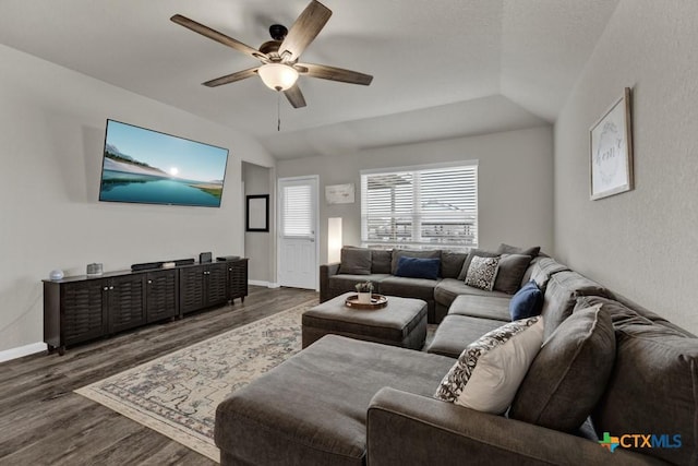 living room with vaulted ceiling, wood finished floors, baseboards, and ceiling fan