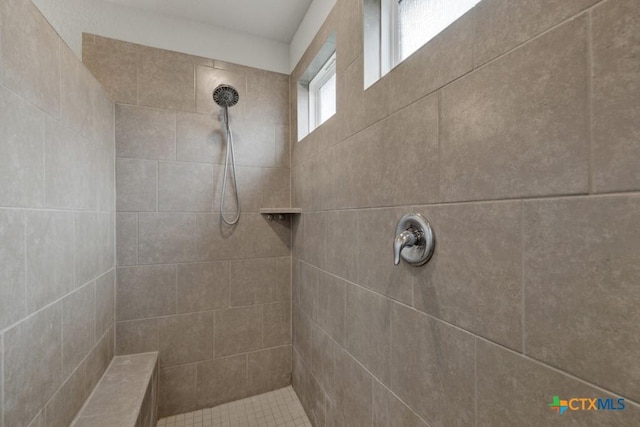 full bath with a tile shower