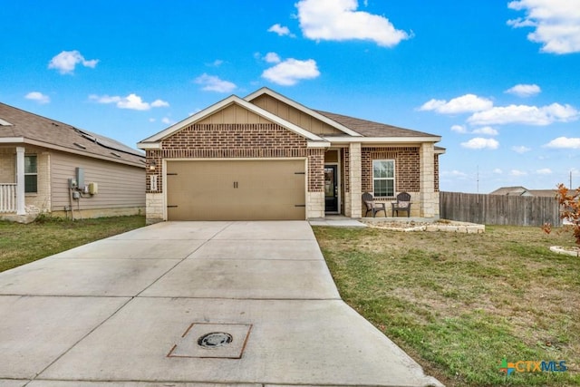 ranch-style home featuring a garage, brick siding, concrete driveway, and a front yard