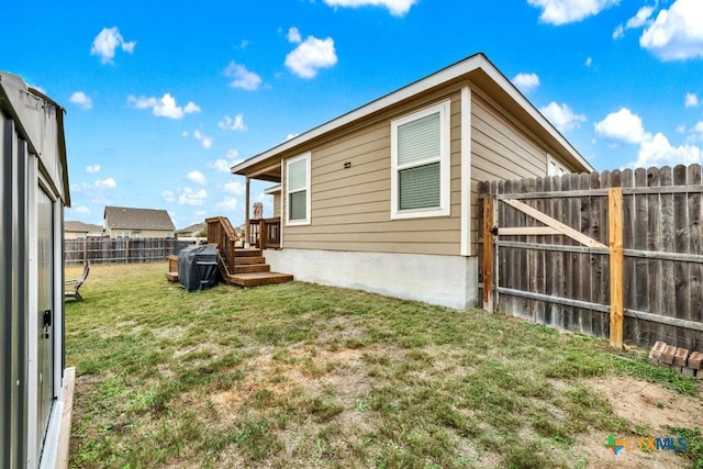 view of property exterior featuring a lawn and a fenced backyard