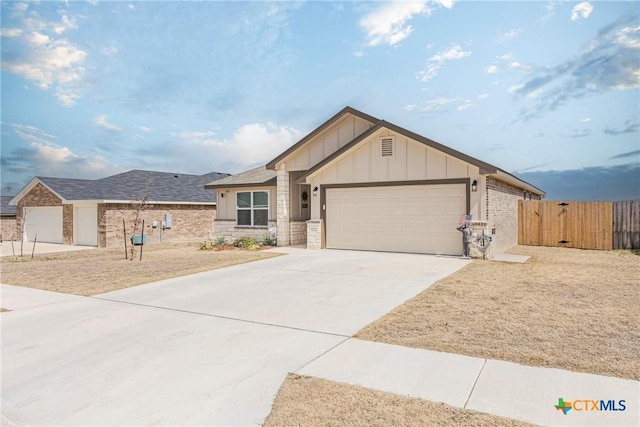 view of front facade with a garage, fence, concrete driveway, a gate, and board and batten siding