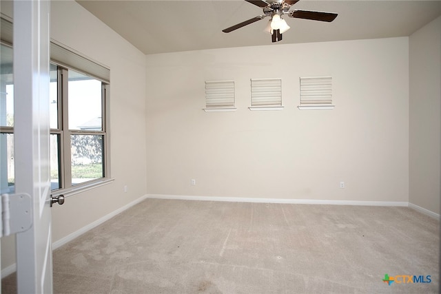 empty room with ceiling fan and light carpet