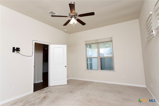 unfurnished bedroom featuring lofted ceiling, light carpet, and ceiling fan