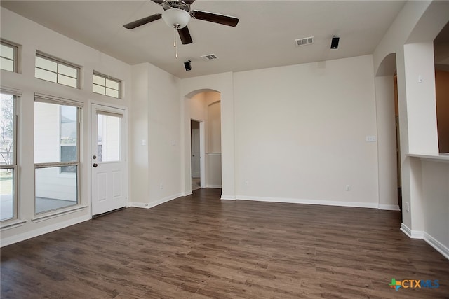 interior space featuring dark wood-type flooring and ceiling fan