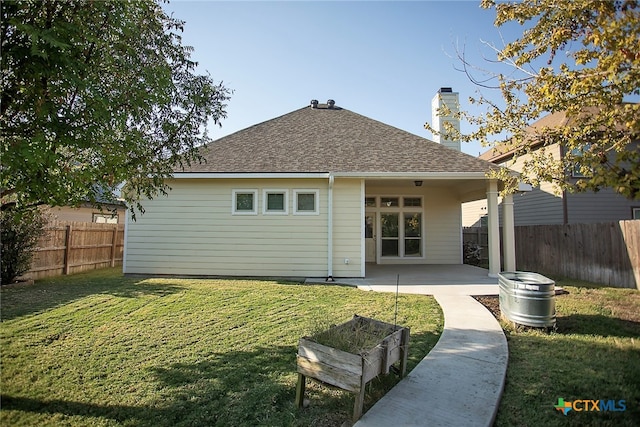 back of property featuring a yard and a patio area