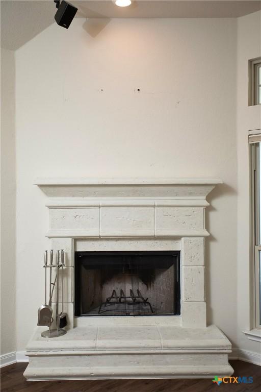 7841 Old Gate Rd, Temple, TX 76502 - detailed view of a fireplace with raised hearth, baseboards, and wood finished floors