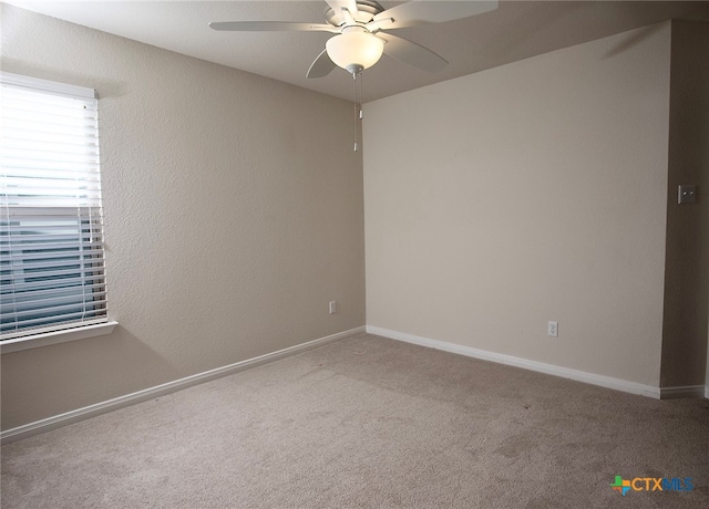 carpeted empty room featuring ceiling fan