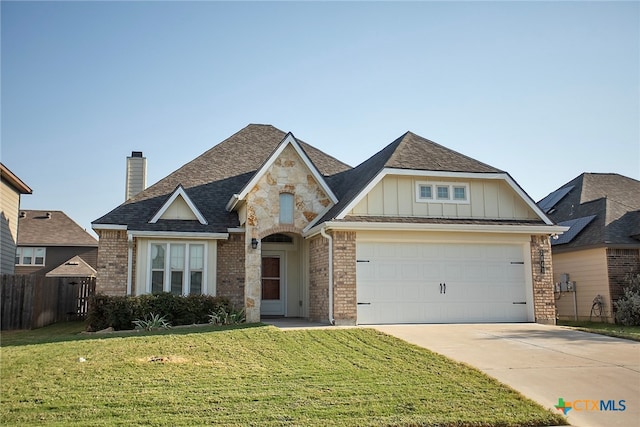 view of front of property with a garage and a front yard