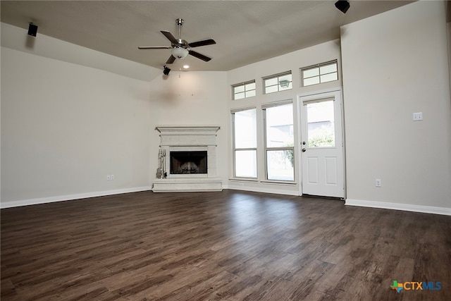 unfurnished living room with ceiling fan and dark hardwood / wood-style floors