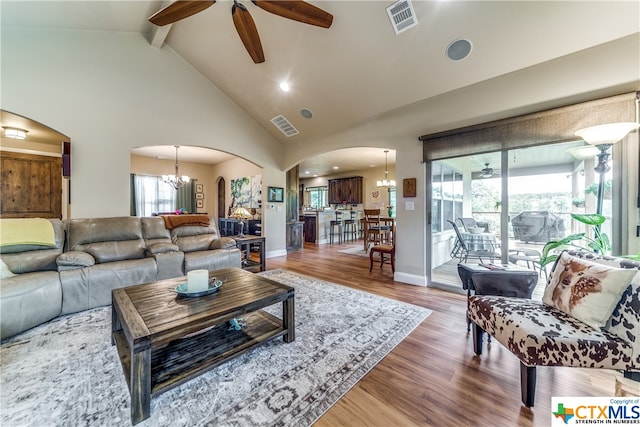 living room featuring beam ceiling, high vaulted ceiling, wood-type flooring, and ceiling fan with notable chandelier