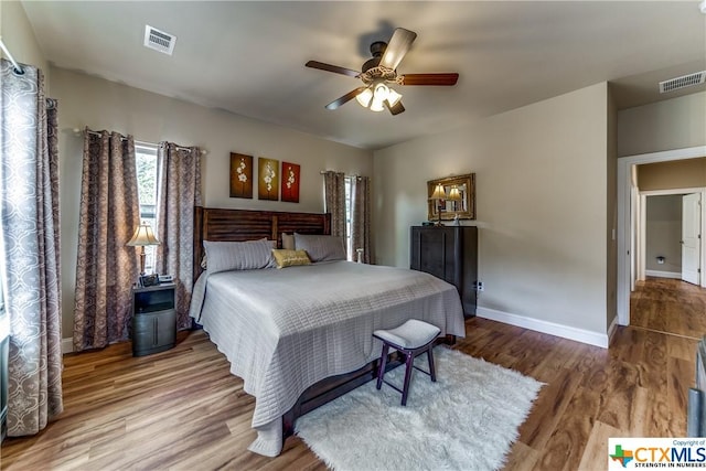 bedroom with ceiling fan and hardwood / wood-style flooring