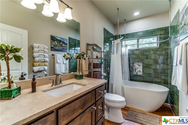 full bathroom featuring a notable chandelier, separate shower and tub, toilet, vanity, and hardwood / wood-style flooring