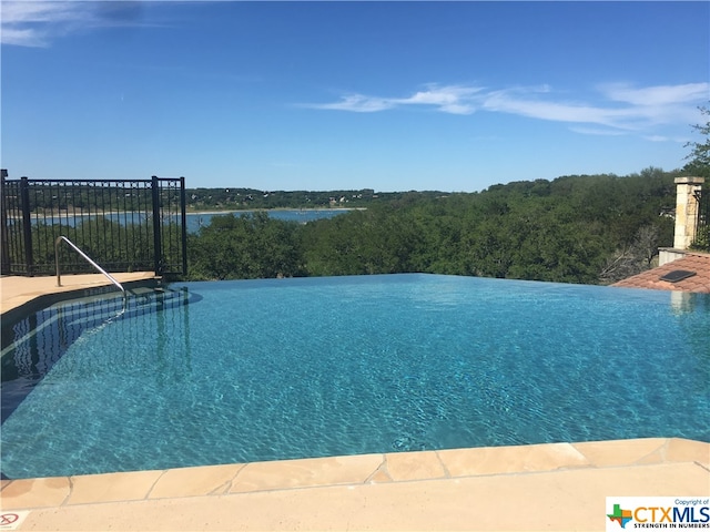 view of pool with a water view