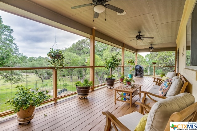 wooden terrace featuring area for grilling and ceiling fan