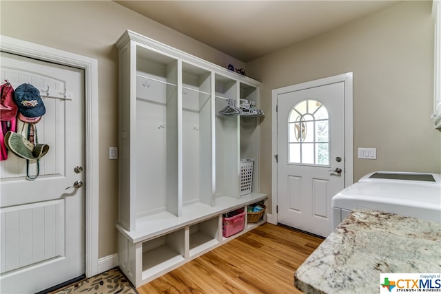 mudroom with washer and dryer and light hardwood / wood-style flooring