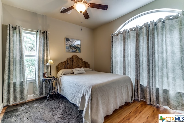 bedroom with hardwood / wood-style flooring and ceiling fan