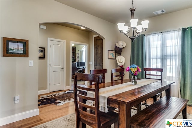 dining room featuring an inviting chandelier and hardwood / wood-style flooring