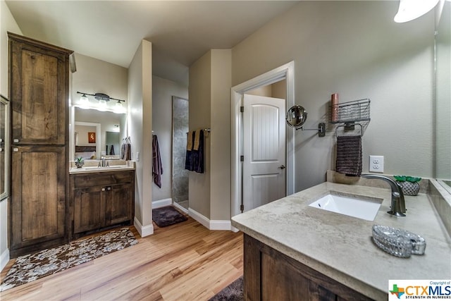 bathroom with vanity and wood-type flooring