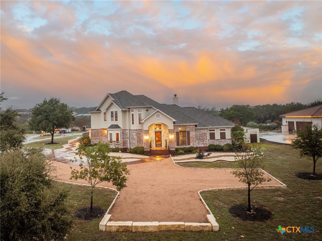 view of front of house with french doors and a lawn