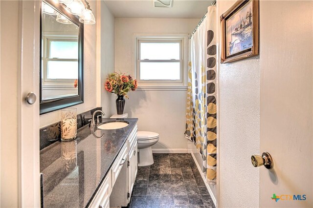 4508 Briar Cliff Rd, Temple, TX 76502 - full bathroom featuring toilet, vanity, plenty of natural light, and baseboards