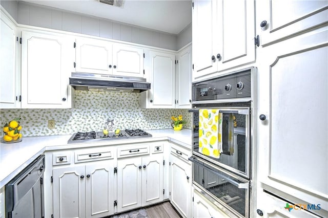 4508 Briar Cliff Rd, Temple, TX 76502 - kitchen with stainless steel gas stovetop, a warming drawer, black oven, under cabinet range hood, and light countertops