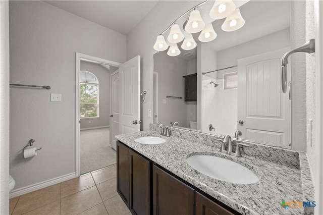 5208 Siltstone Loop, Killeen, TX 76542 - bathroom with toilet, baseboards, tile patterned flooring, double vanity, and a shower