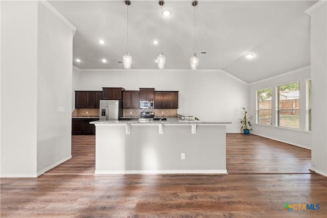 5208 Siltstone Loop, Killeen, TX 76542 - kitchen with stainless steel appliances, ornamental molding, a large island, vaulted ceiling, and dark brown cabinetry