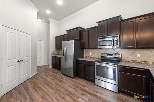 5208 Siltstone Loop, Killeen, TX 76542 - kitchen with appliances with stainless steel finishes, crown molding, dark brown cabinets, backsplash, and light stone countertops