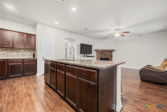 606 Hobby Rd, Copperas Cove, TX 76522 - kitchen featuring a sink, a ceiling fan, stainless steel dishwasher, arched walkways, and wood finished floors