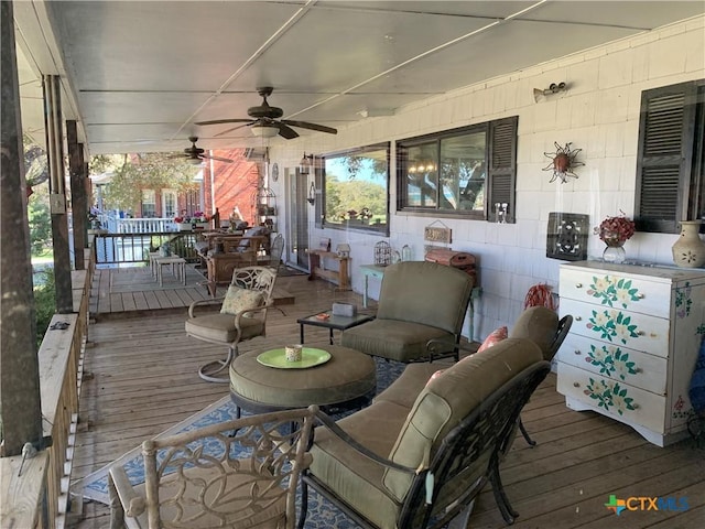 wooden terrace with a ceiling fan and covered porch