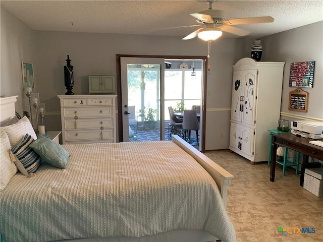 bedroom with access to exterior, light colored carpet, ceiling fan, and a textured ceiling