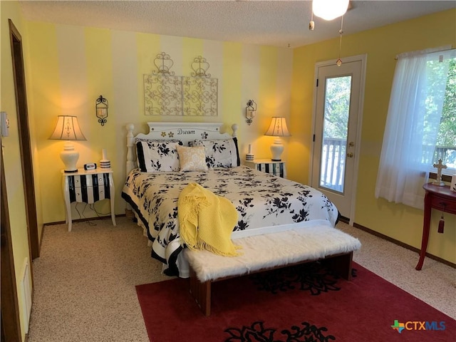 bedroom featuring a textured ceiling, access to outside, and baseboards