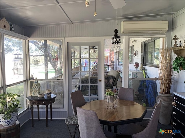 sunroom / solarium featuring a healthy amount of sunlight, a wall mounted AC, and carpet