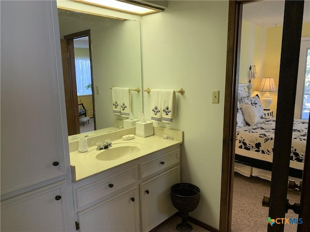 bathroom featuring ensuite bath and vanity