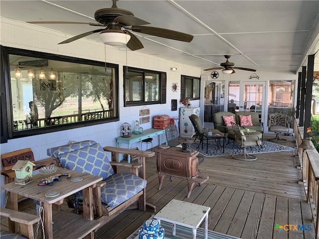 sunroom / solarium featuring ceiling fan