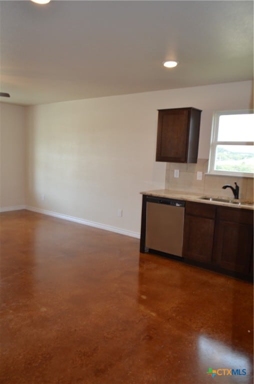 kitchen with tasteful backsplash, stainless steel dishwasher, sink, and dark brown cabinets