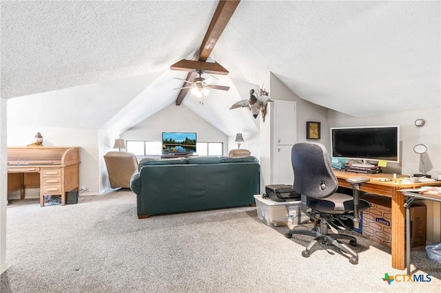 carpeted office space featuring ceiling fan, lofted ceiling with beams, and a textured ceiling