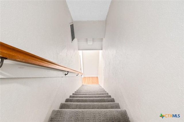 stairway with a textured wall