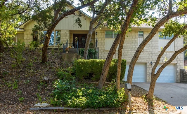 view of front of house with brick siding and driveway