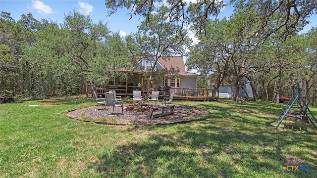 689 Abels Way, Canyon Lake, TX 78133 - view of green lawn featuring an outdoor fire pit and a wooden deck