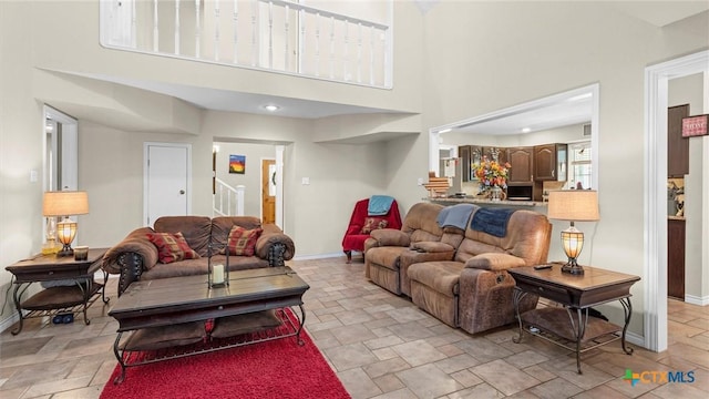689 Abels Way, Canyon Lake, TX 78133 - living room featuring stone tile flooring and a towering ceiling