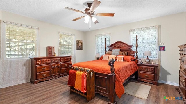 689 Abels Way, Canyon Lake, TX 78133 - bedroom featuring wood finished floors, a ceiling fan, and a textured ceiling